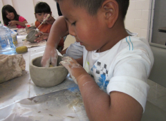 Young child working with ceramics