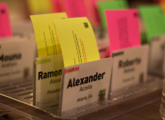 Several name tags with bright sticky papers coming out of the top
