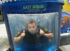 A police officer in a water tank giving a thumbs up