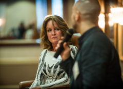 Image of a woman listening to a man speak
