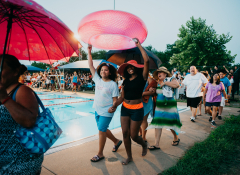Featuring over 50 neighborhood residents, Dove Springs Swims (2018) began with a celebratory community paseo around the pool. Photo by Jonica Moore.