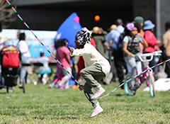 A young girl playing jump rope