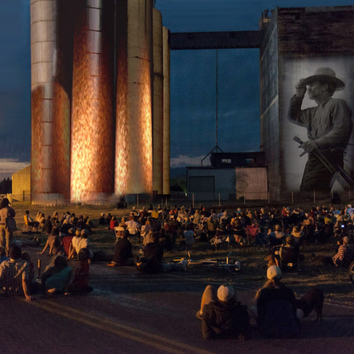 Images projected on a mill while an audience watches