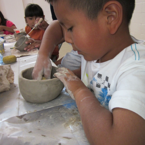 Young child working with ceramics