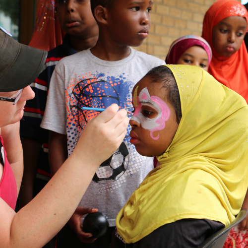 Participants at a Mixed Blood health fair get their face painted