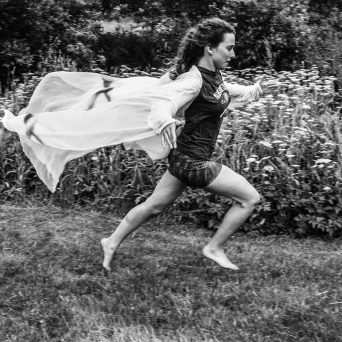 Black and White photo of dancer in a field.