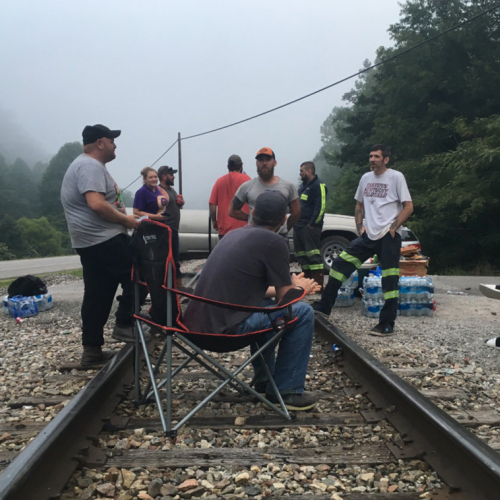 Image of a film crew on an abandoned train track. 