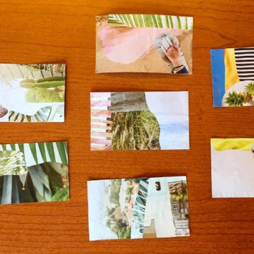 A series of postcards on a brown wooden table