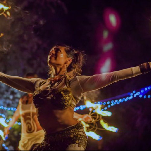 Tanya Blacklight performing with fire at night