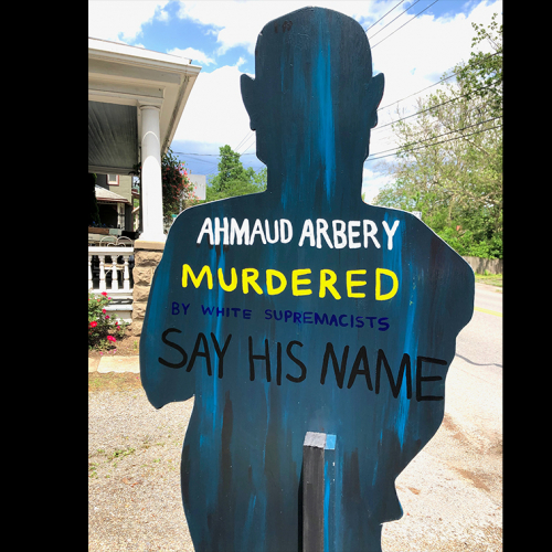 A cardboard cut out with the words "Ahmaud Arbery. Murdered. Say His Name."