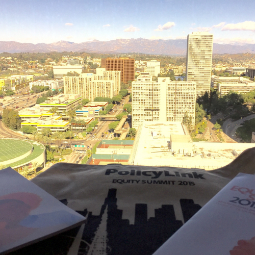 Landscape image of Los Angeles with papers on a desk