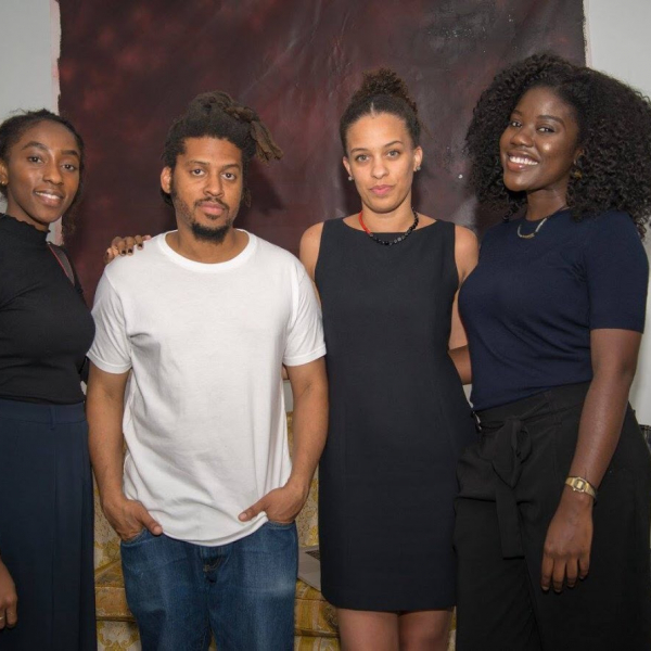 A group photo featuring three black women and one black man. 