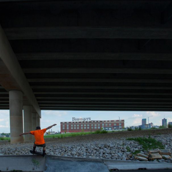 Young black child playing under an interstate