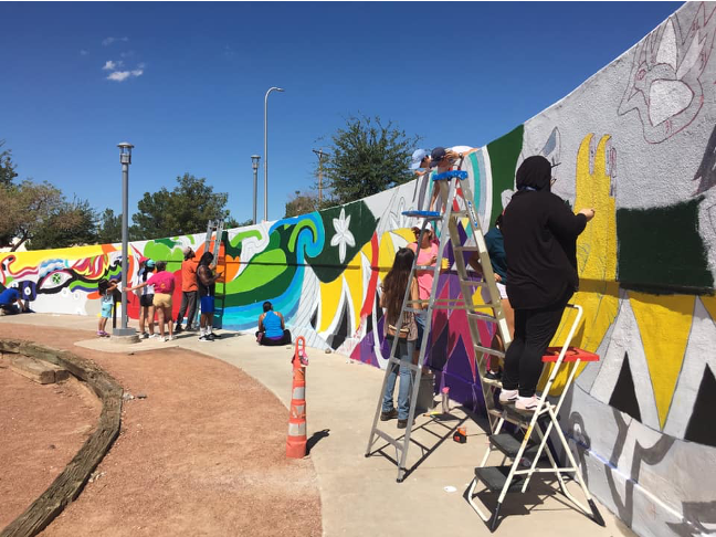 Las Cruces community members painting the &quot;Tierra Sagrada&quot; mural at the Branigan Memorial Public Library